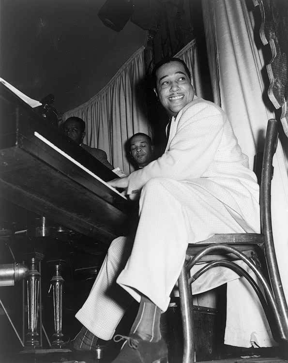 Duke Ellington playing the piano and smiling in 1943