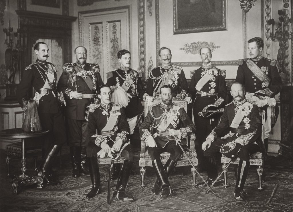 Photograph of 9 monarchs together in military uniform in a fancy room in Windsor Castle in May 1910. Standing, from left to right: Haakon VII of Norway, Ferdinand of Bulgaria, Manuel II of Portugal, Wilhelm II of Germany, George I of Greece, and Albert I of Belgium. Seated, from left to right: Alfonso XIII of Spain, George V of the United Kingdom, and Frederick VIII of Denmark.