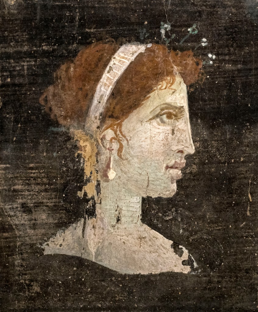 Egyptian Pharaoh Cleopatra painted with red hair and distinct facial features.