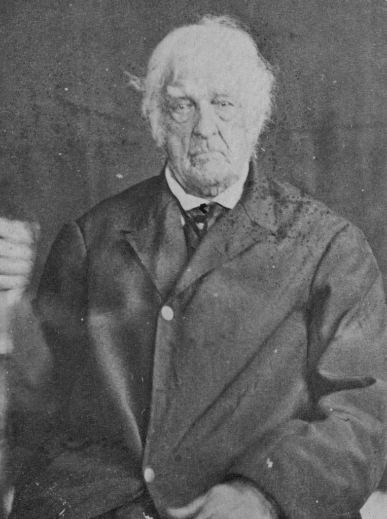 Photograph of American Revolutionary War veteran, Lemuel Cook, at the age of 104 wearing formal clothing in 1864.