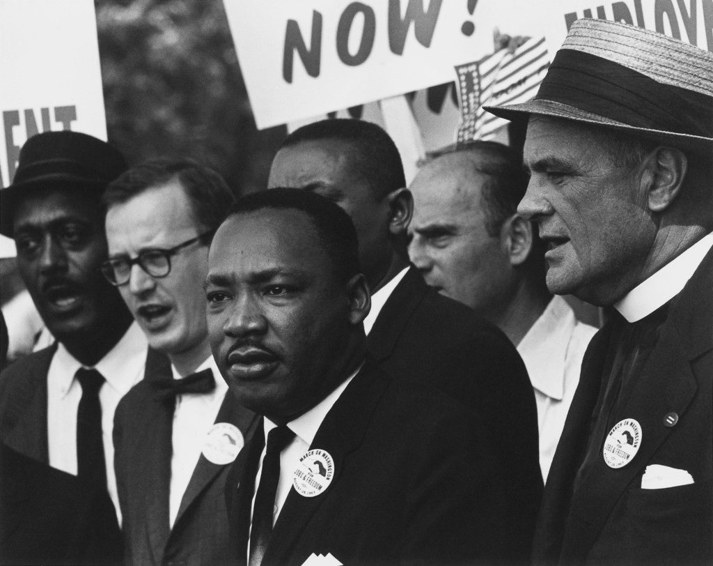 Historical photograph of Martin Luther King jr. in a suit during the March on Washington in august 1963.