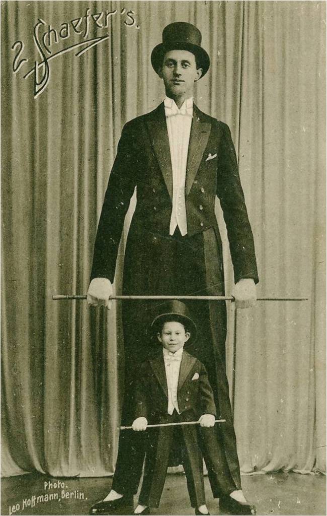 The world tallest man, Jakob Nacken in a tuxedo and top hat posing for a photograph with a small boy also wearing a tuxedo and top hat for the circus in 1924. Nacken went on to become the tallest soldier in the German Army and World War 2