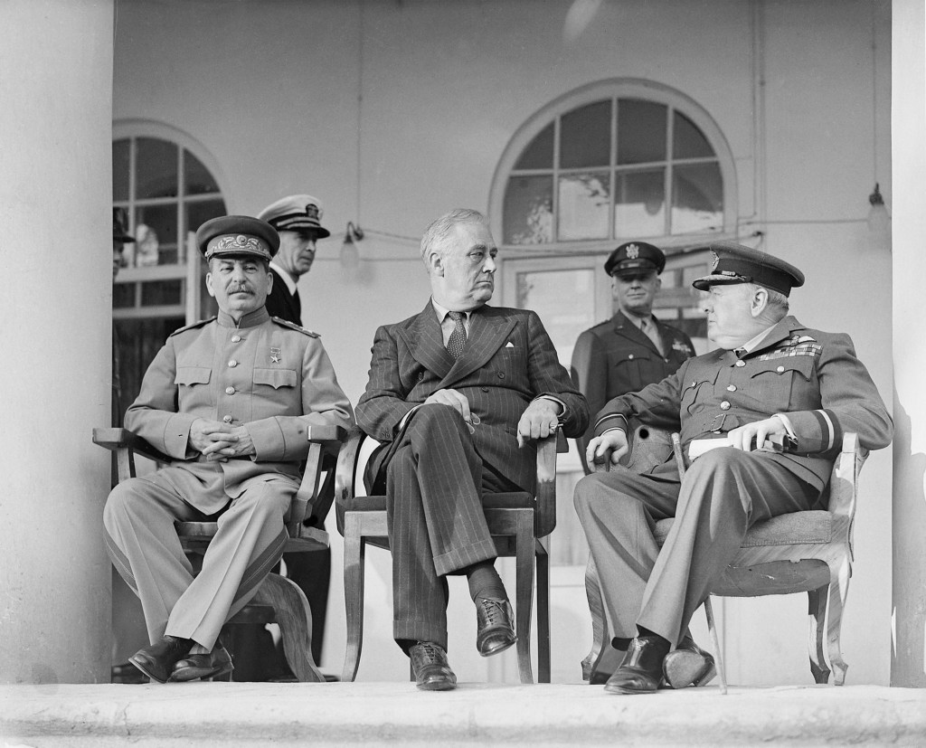 Josef Stalin, Franklin D. Roosevelt, and Winston Churchill sitting for a photograph at the Tehran Conference in November 1943.