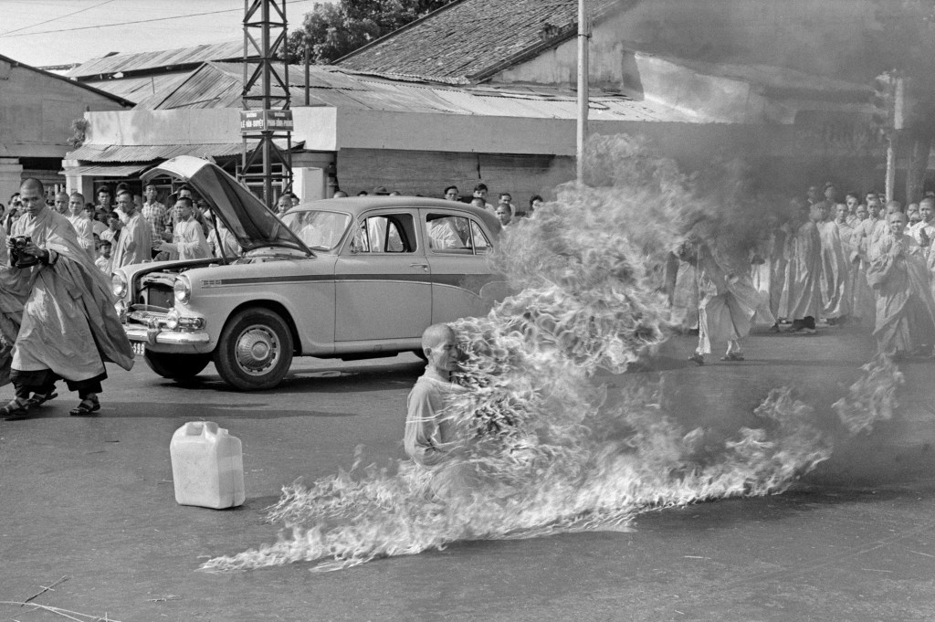 Photograph of Thích Quảng Đức's self-immolation. You can see him on fire on a street in saigon in June 1963