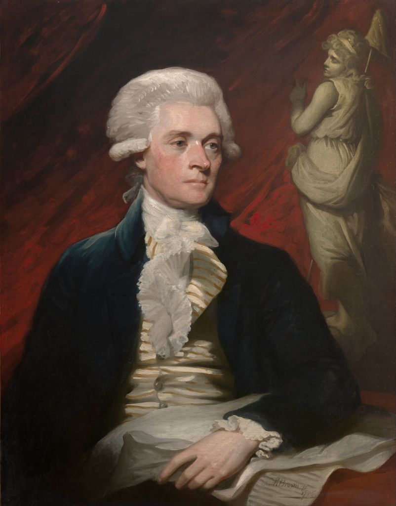 One of the main founding fathers, George Washington, painted in formal clothing in front of a red background. He has white hair in his famous style in this painting by Gilbert Stuart.