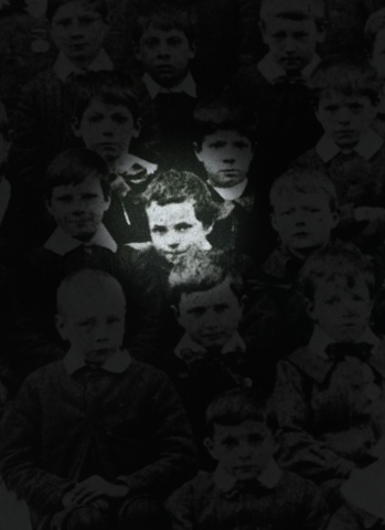 Charlie Chaplin as a 7 year old boy within a school photo alongside other children.