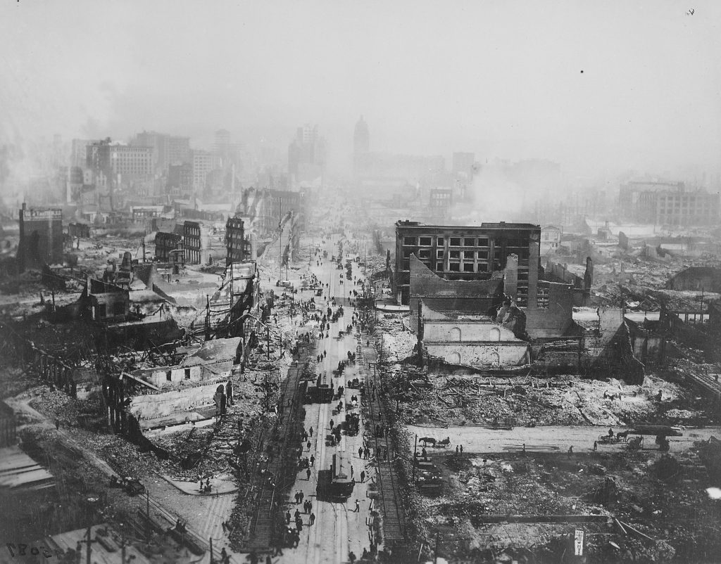 The ruins of San Francisco, still smoldering after the 1906 earthquake, taken from the tower of the Union Ferry Building. Market Street between Sacramento and Third Streets