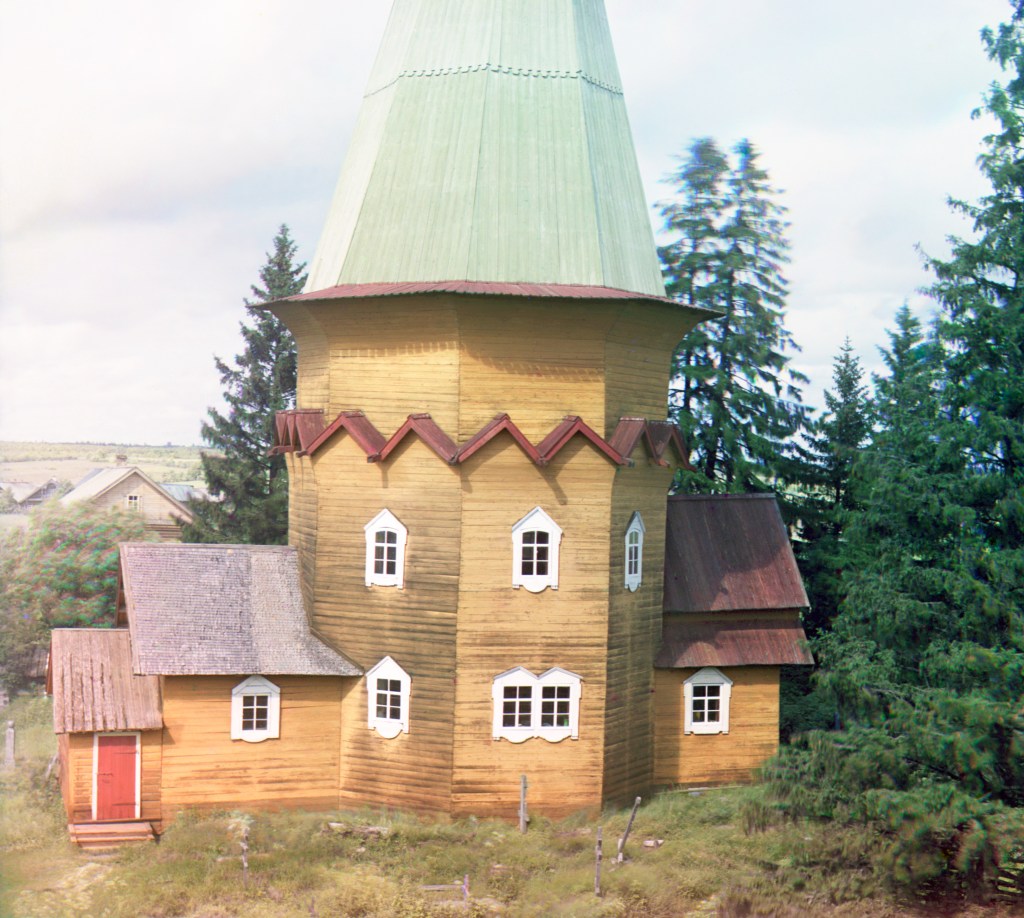 Yellow wooden church in Pid'ma, Russia