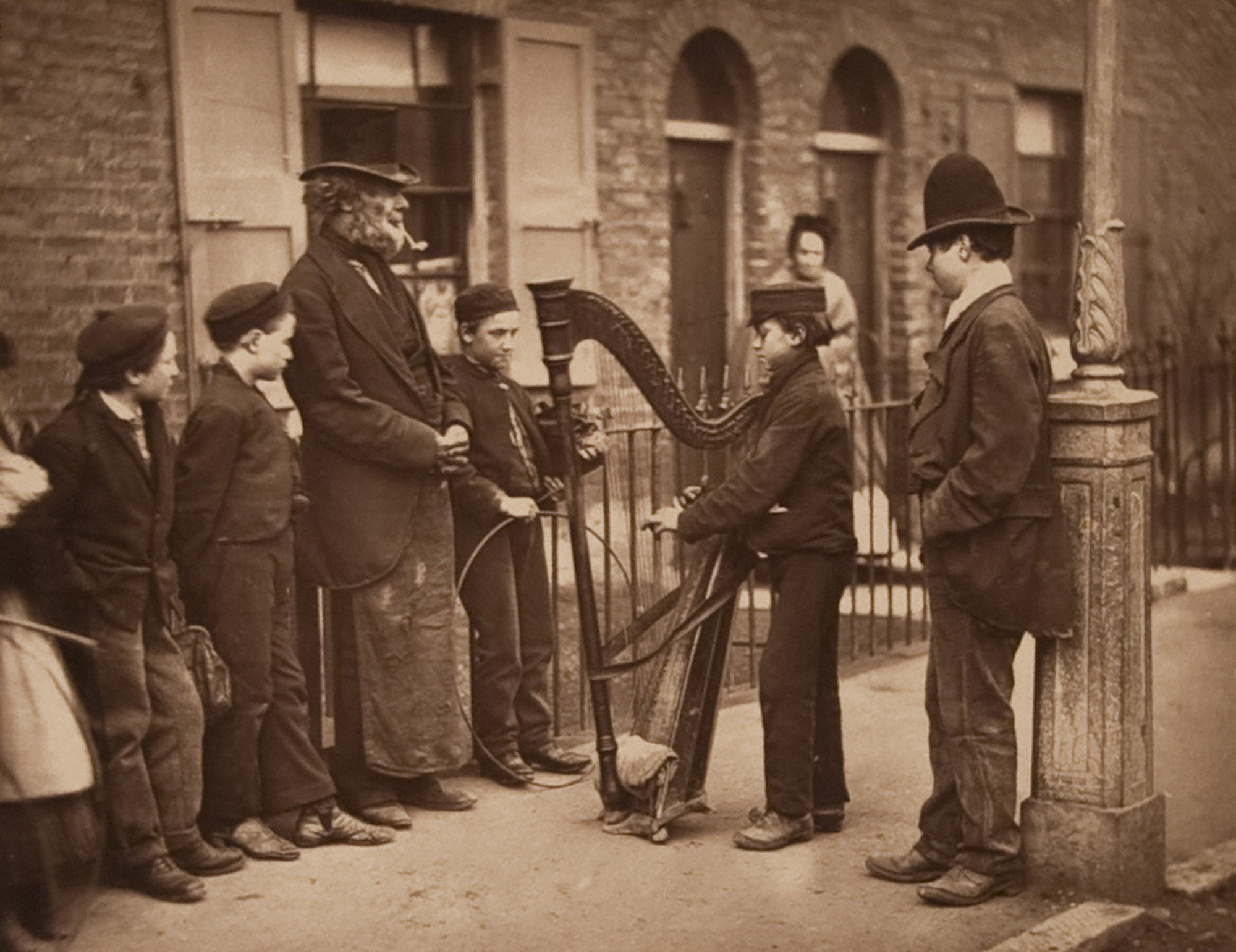 Italian Street Musicians in London. One is holding a harp.