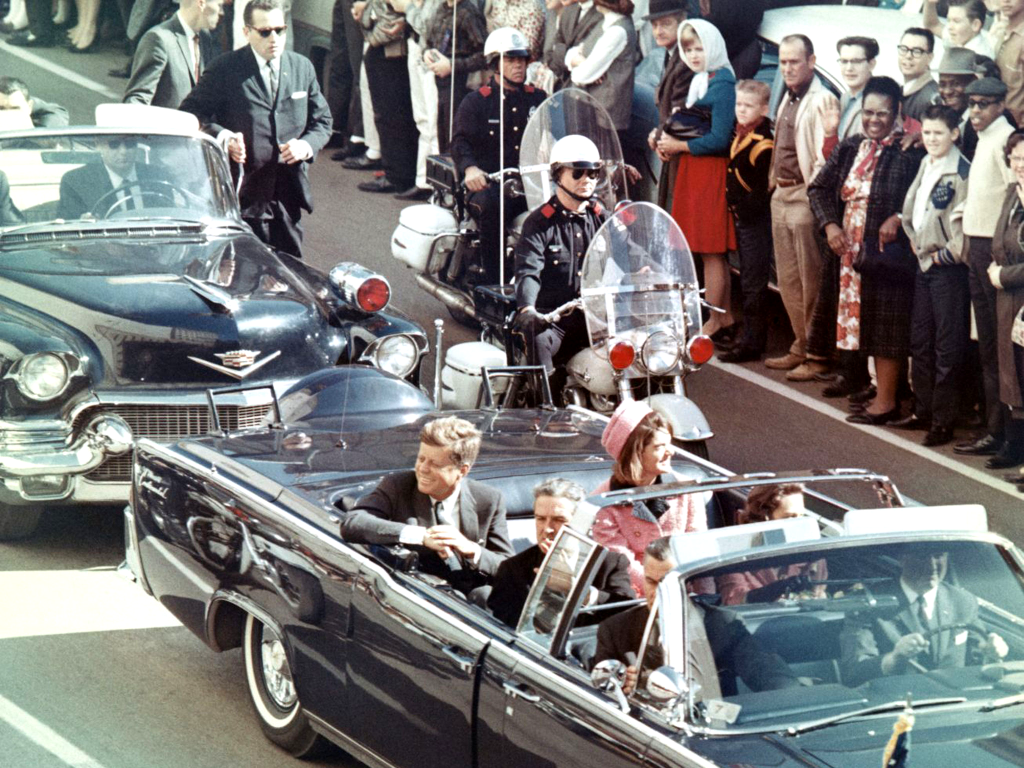 Picture of President Kennedy in the limousine in Dallas, Texas, on Main Street, minutes before the assassination. Also in the presidential limousine are Jackie Kennedy, Texas Governor John Connally, and his wife, Nellie
