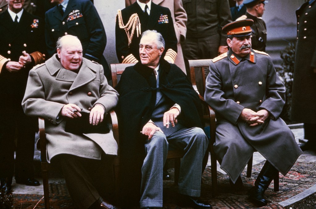 Kodachrome color photograph of Franklin Roosevelt (center), Winston Churchill (left) and Joseph Stalin (right) sitting at the Yalta Conference.