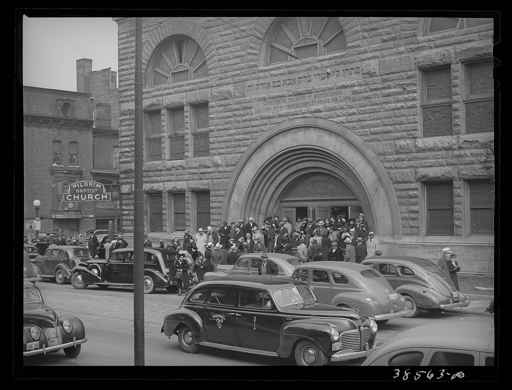 Original black and white version of a crowd of people leaving Pilgrim Baptist Church located Southside of Chicago, Illinois, United States.