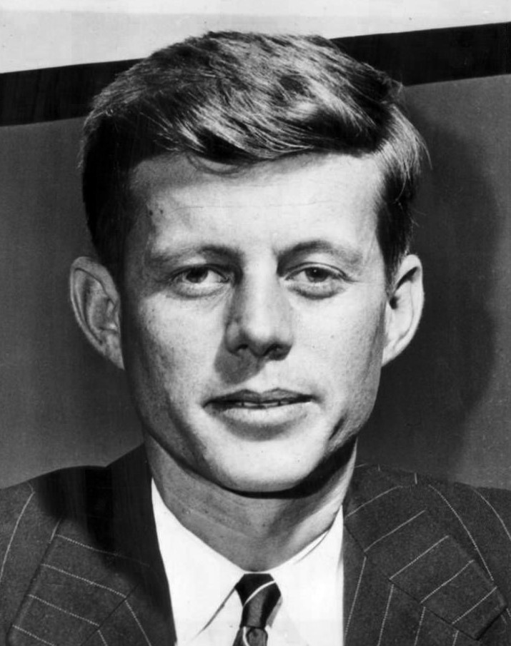 Portrait of a 30-year-old John F. Kennedy in a suit and tie.