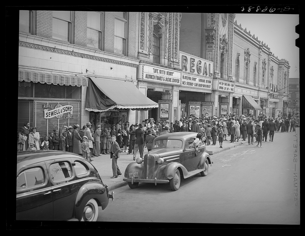 Photo of a line of people waiting to enter the Regal Theater in Chicago, Illinois, United States.