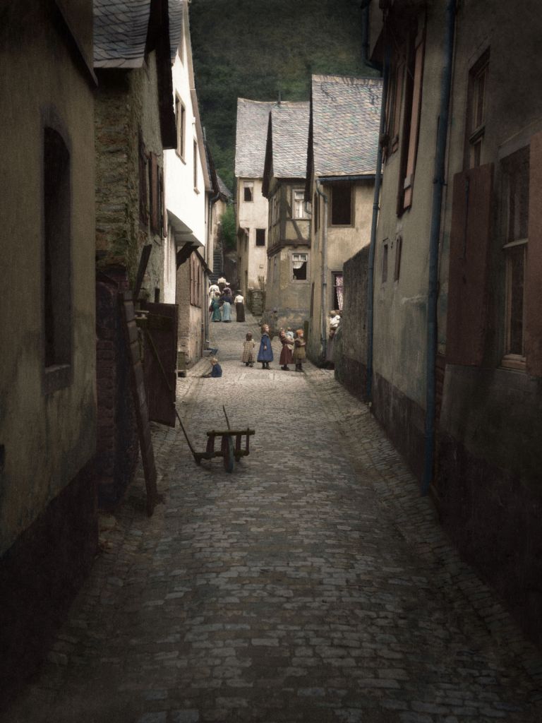 Early 20th-century photo taken by Arnold Genthe of a street in an unknown town in Europe, likely northern France or Belgium.