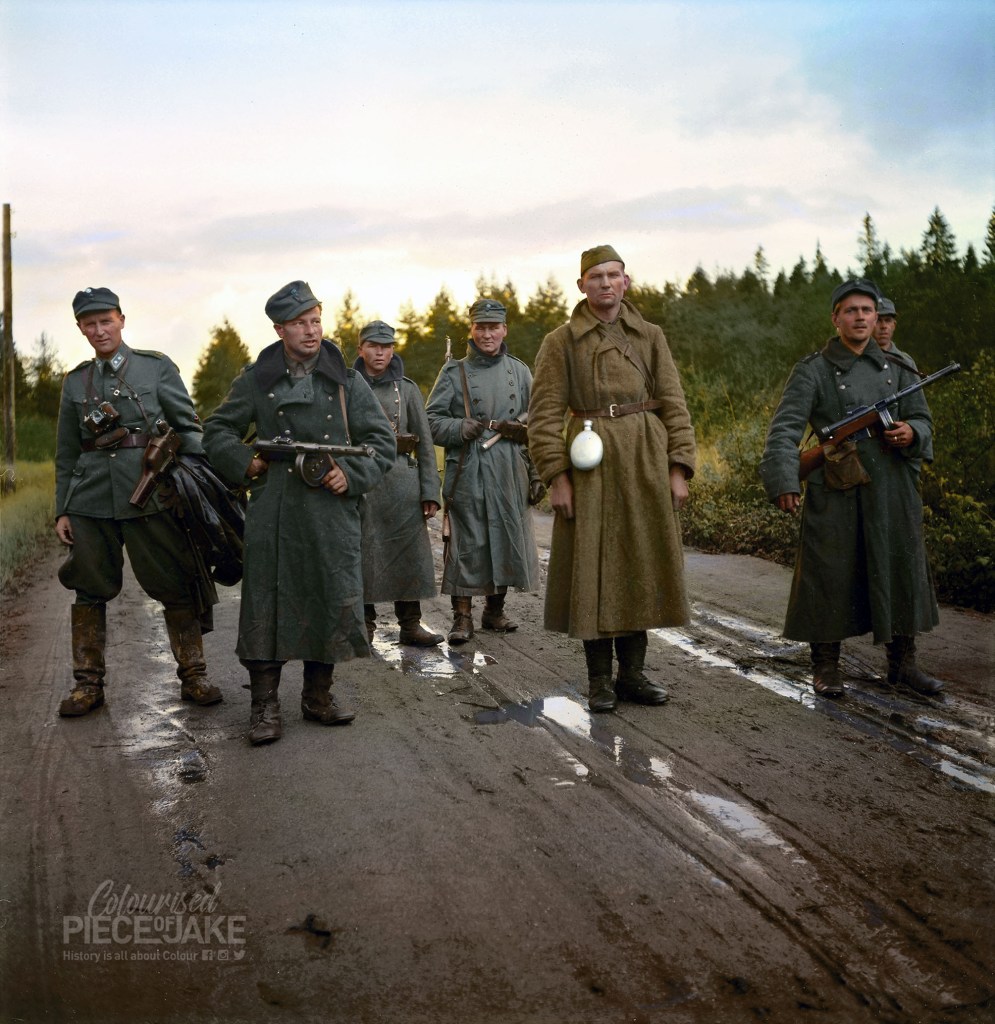 Colorized photograph of a Russian Prisoner of War escorted through Kirjasalo by Finnish soldiers. Colourised Piece of Jake colorized this image
