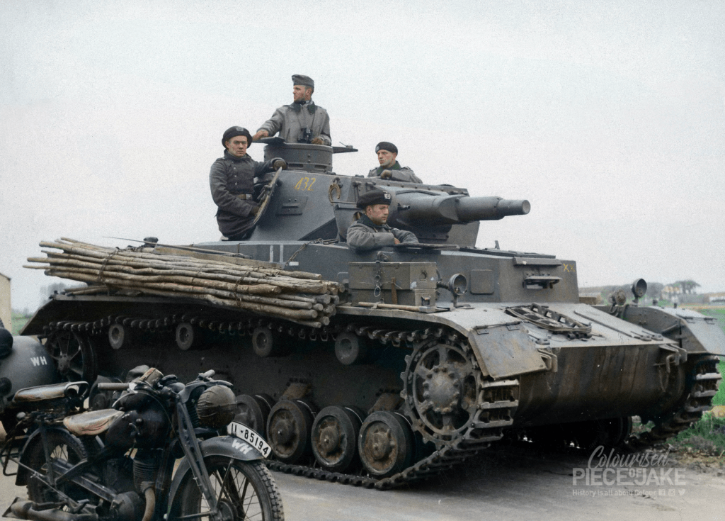 German Panzerkampfwagen IV, Ausführung D, of 9. Panzerdivision during the advance in May 1940, presumably in the vicinity of Moerdijk. The number '432' on the turret stands for 4. Kompanie, 3. Zug (platoon), 2. Fahrzeug. A DKW NZ350 motorcycle of the Wehrmacht is visible in the foreground. Colorized by Colourised Piece of Jake