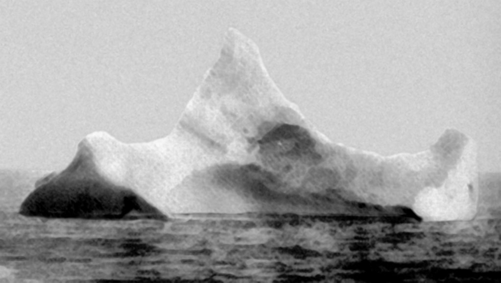 The iceberg suspected of having sunk the RMS Titanic photographed by the chief steward of the ship Prinz Adalbert on the morning of April 15, 1912, a few miles south of where Titanic sank. The steward hadn't yet heard about Titanic's sinking. What caught his attention was the smear of what appeared to be red paint along the base of the berg, suggesting it had collided with a ship.