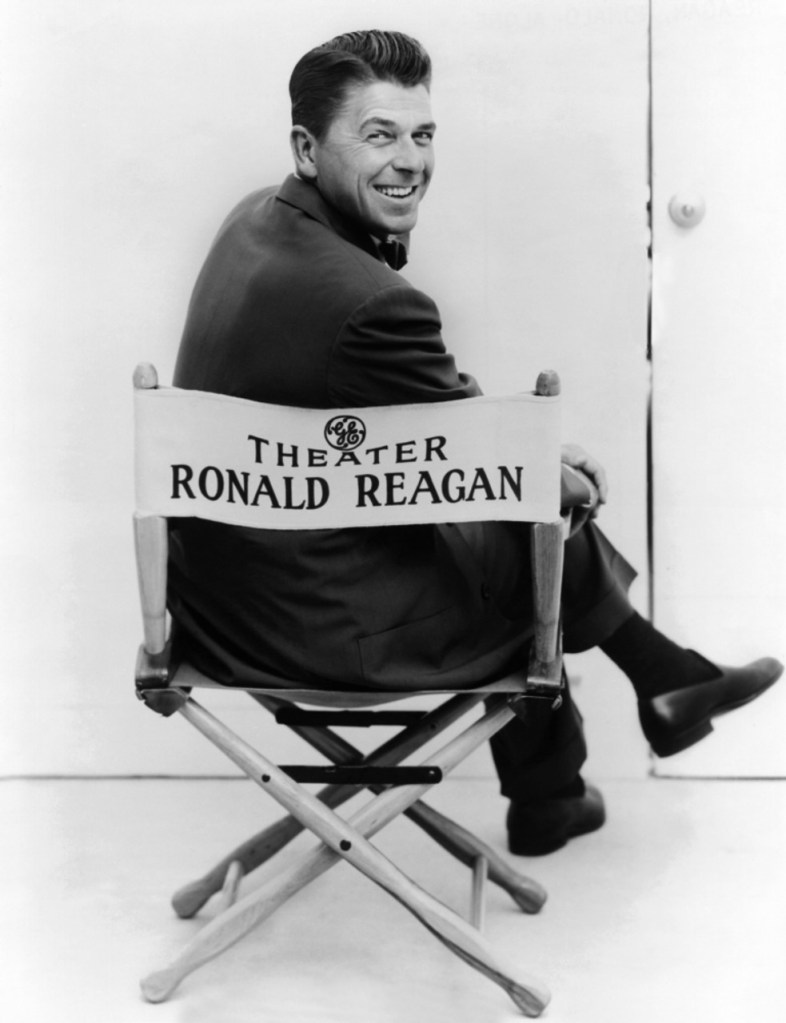 Publicity photograph for the General Electric Theater anthology series in which the host of the show, Ronald Reagan, is photographed sitting in the director's chair.