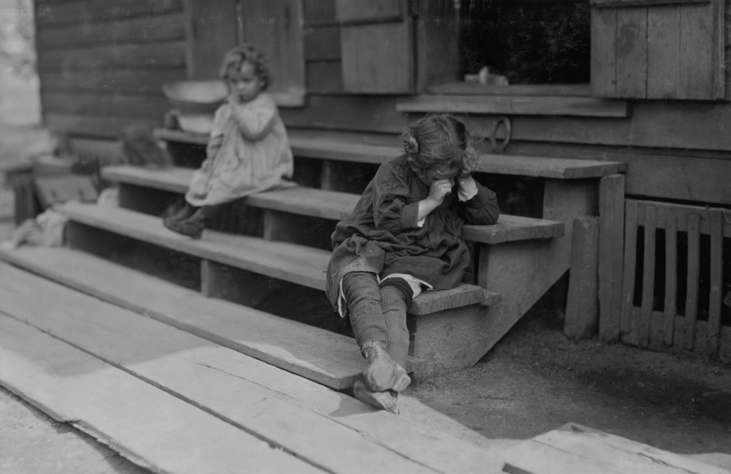 Original description: Olga Schubert, 855 Gruenwald St. The little 5 yr. old after a day's work that began about 5:00 A.M. helping her mother in the Biloxi Canning Factory, begun at an early hour, was tired out and refused to be photographed. The mother said, "Oh, She's ugly." Both she and other persons said picking shrimp was very hard on the fingers. See also photo 2021. Location: Biloxi, Mississippi.
