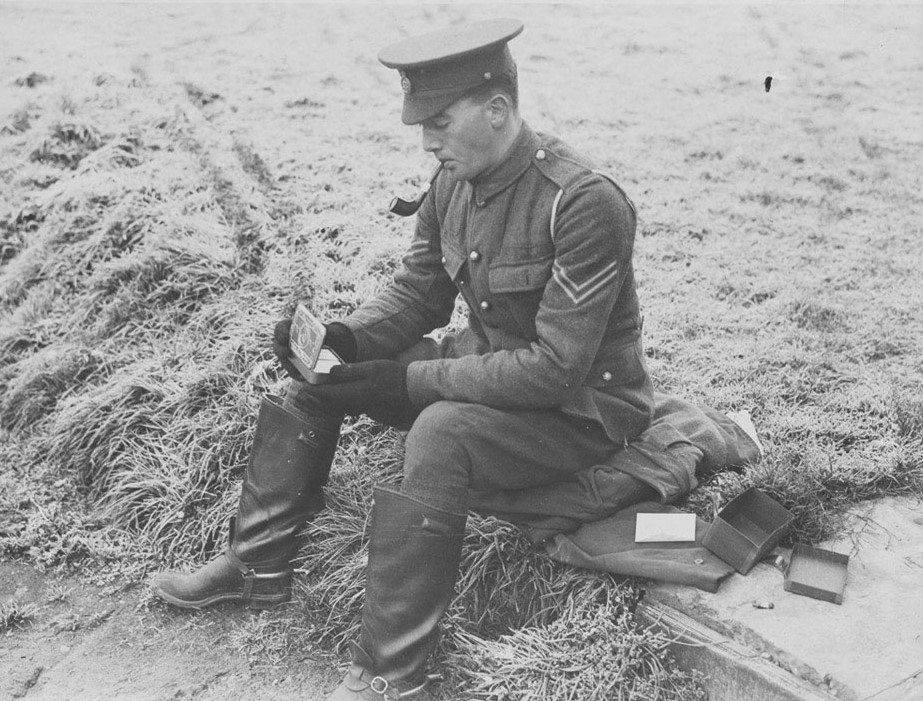 A soldier opening his Princess Mary Gift Tin, Christmas 1914