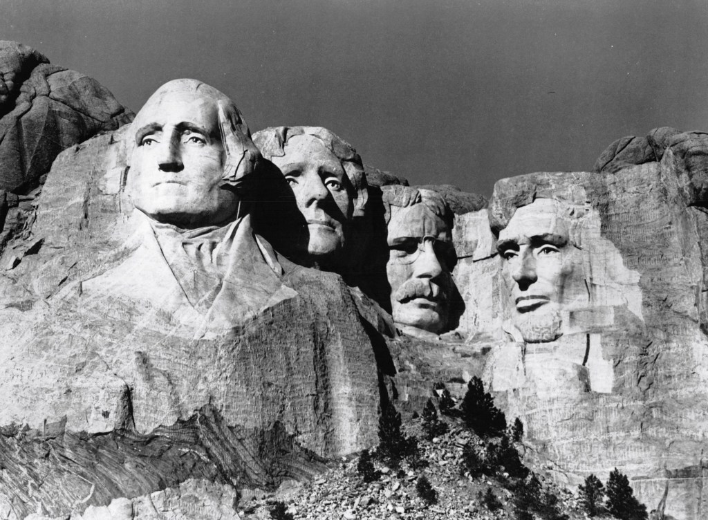 black and white of the Mount Rushmore National Memorial - four faces  after construction. Photograph printed in 1976