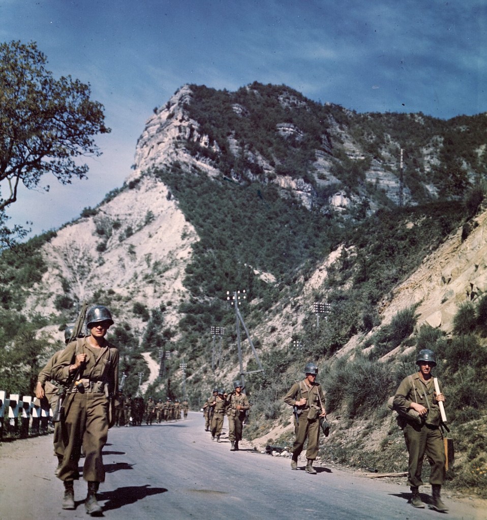 Infantrymen of the 88th Division march along picturesque mountain highway #64 leading to Bologna. Little resistance was encountered in this sector.