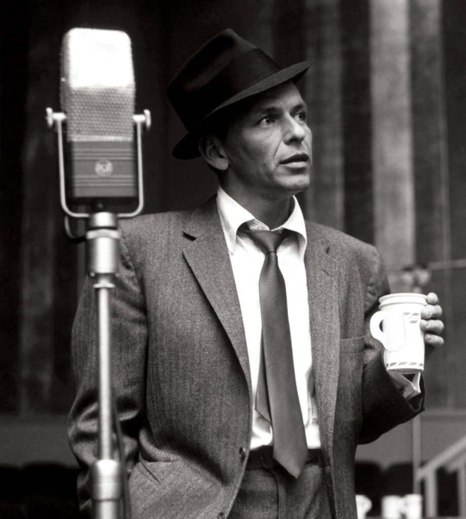 " Frank Sinatra with a paper coffee cup in Capitol Records Studio A during the recording of his 1956 album Songs for Swingin' Lovers!" via Wikimedia Commons
